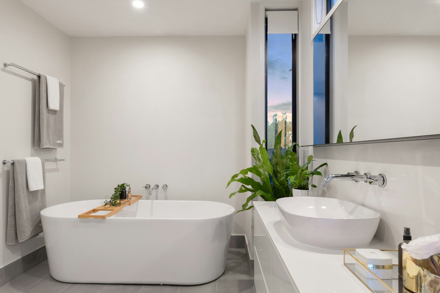 White bathroom with a freestanding tub and vessel basin