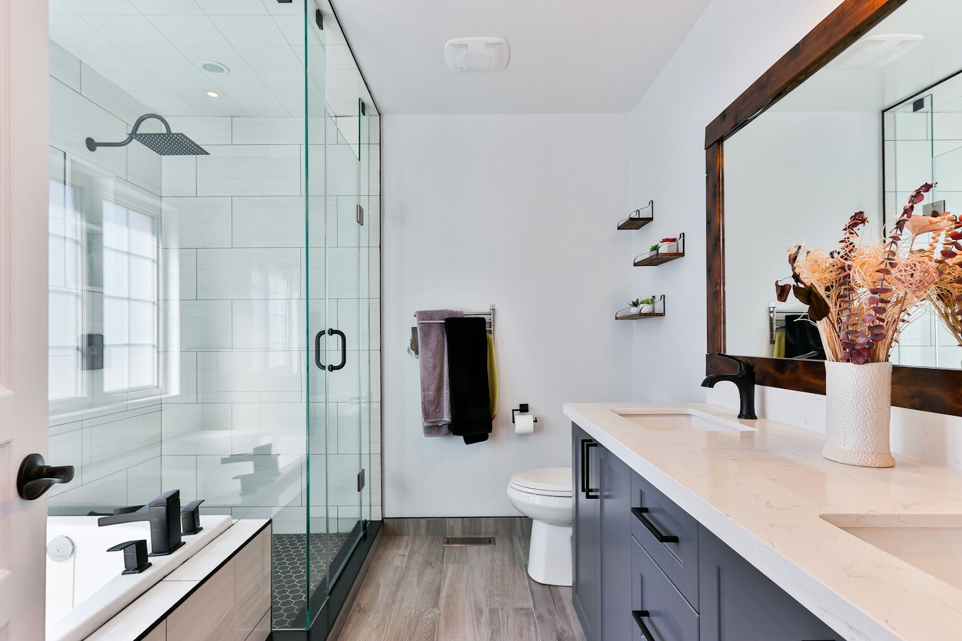 Bathroom with a glass shower enclosure and dark vanity