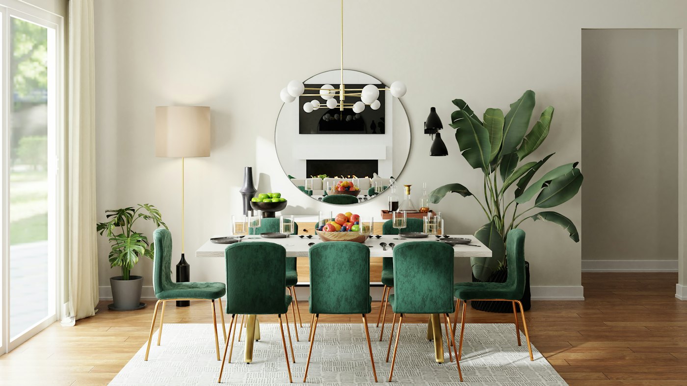 Dining area with green velvet chairs, a black table and a round mirror