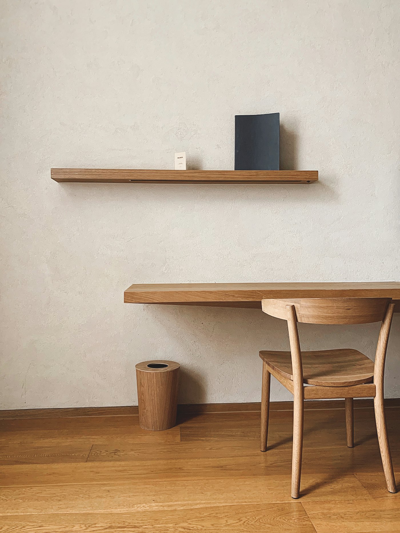 Wall-mounted light-oak study desk with a floating shelf