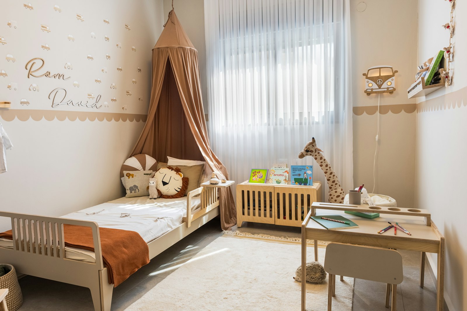 Natural-wood kids room with a canopy bed, toy storage and a small play table