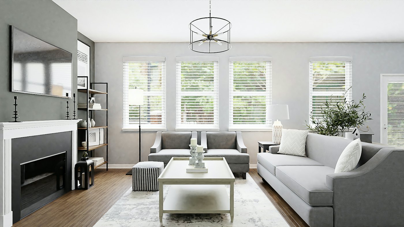 Bright grey-and-white living room with a sectional sofa and plantation shutters