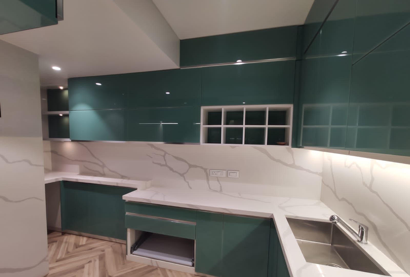Sink run with open display shelving in the emerald glass kitchen