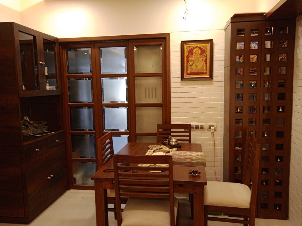 Dining table beside a glass-front crockery unit