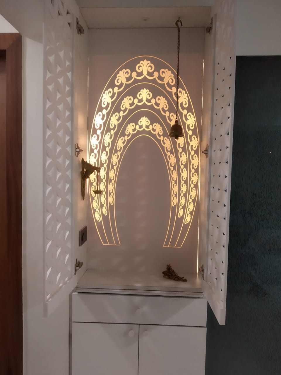 Mandir with a backlit jali arch