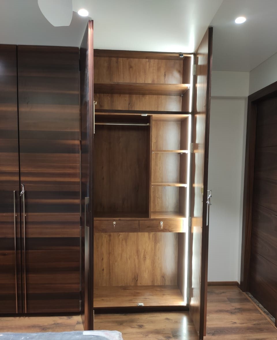 Walnut wardrobe with lit open shelving