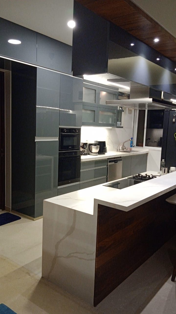 Waterfall island with walnut panel and grey tall units