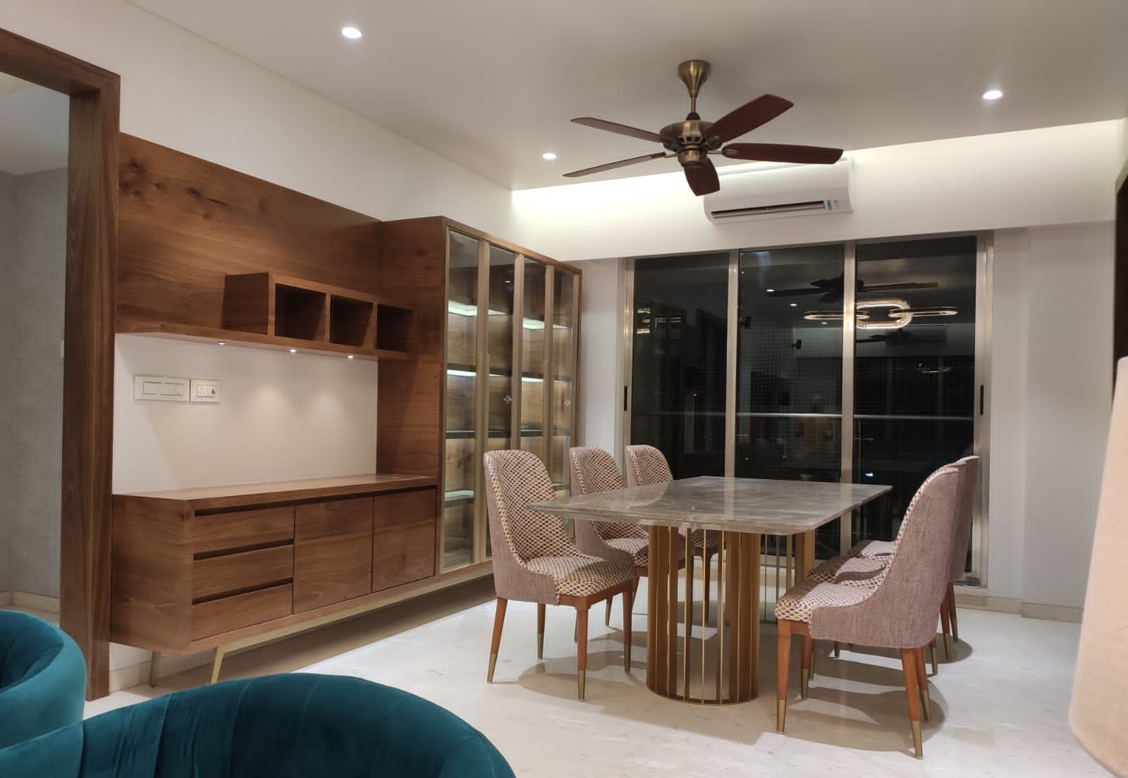 Living and dining zones with a walnut display wall